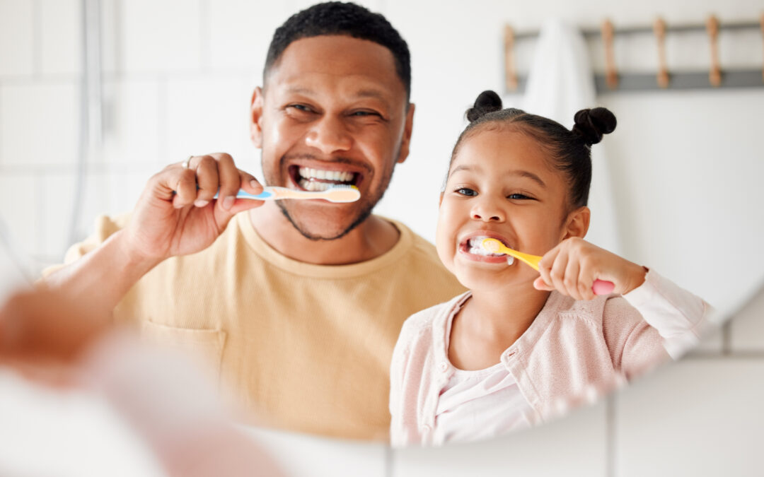 dad and daughter brushing their teeth